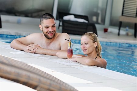 simsearch:400-04258029,k - happy young couple in love have fun  relax and  drink coctail at indoor wellness swimming pool Foto de stock - Royalty-Free Super Valor e Assinatura, Número: 400-04816862