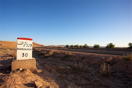 Road Sign to Ouarzazate in Morocco with blue sky Stock Photo - Budget Royalty-Free & Subscription, Code: 400-04817128