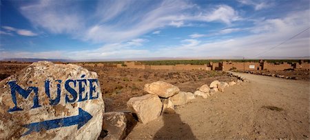 Blue arrow and museum painted on a stone in a small desert village in the south of Morocco Stock Photo - Budget Royalty-Free & Subscription, Code: 400-04817134