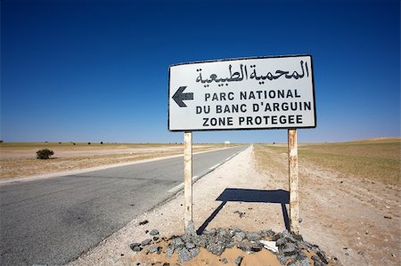 Sign road indicating the direction to the Banc d'Arguin National Wildlife Park in Mauritania Stock Photo - Budget Royalty-Free & Subscription, Code: 400-04817201