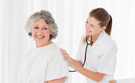 Pretty nurse taking the heartbeat of her patient Stock Photo - Budget Royalty-Free & Subscription, Code: 400-04819565
