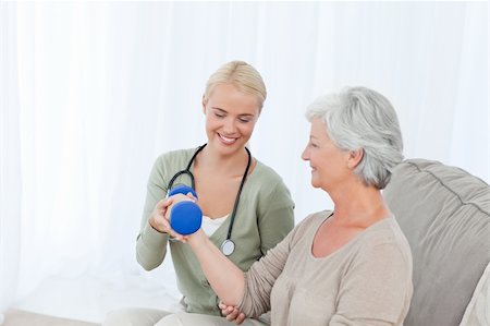 simsearch:400-04311151,k - Beautiful nurse helping her patient to do exercises Stockbilder - Microstock & Abonnement, Bildnummer: 400-04819576