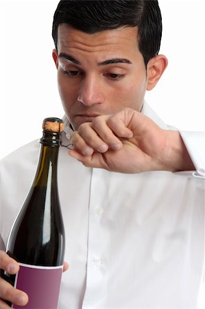 simsearch:400-04313696,k - Closeup of a man or bartender holding and opening a bottle of wine or champagne.  White background. Photographie de stock - Aubaine LD & Abonnement, Code: 400-04810596