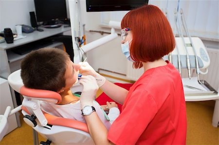 simsearch:400-04309650,k - Image of young lady with dentist over her checking oral cavity Stock Photo - Budget Royalty-Free & Subscription, Code: 400-04811328