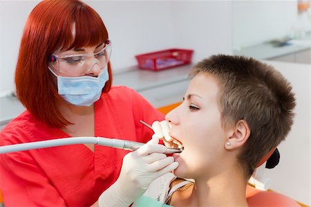 simsearch:400-04309650,k - Image of young lady with dentist over her checking oral cavity Stock Photo - Budget Royalty-Free & Subscription, Code: 400-04811329