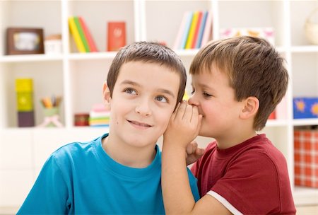 Two mischievous boys sharing a secret - closeup Stock Photo - Budget Royalty-Free & Subscription, Code: 400-04811572