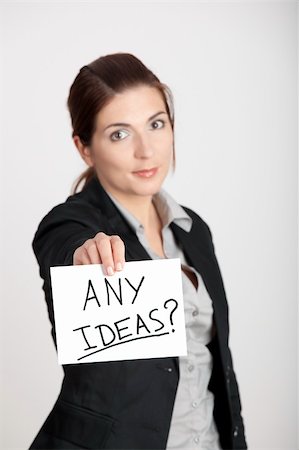 simsearch:400-04648812,k - Business woman holding a card board with the text message "Any Ideas". Focus is on the card Stock Photo - Budget Royalty-Free & Subscription, Code: 400-04812091