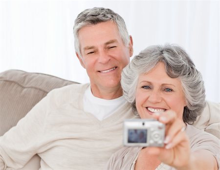 Mature couple taking a photo of themselves at home Stock Photo - Budget Royalty-Free & Subscription, Code: 400-04813139