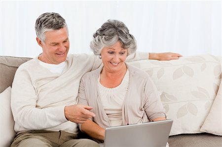 Retired lovers looking at their laptop Stock Photo - Budget Royalty-Free & Subscription, Code: 400-04813130