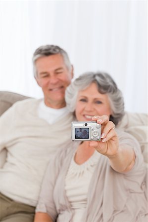 Mature couple taking a photo of themselves at home Stock Photo - Budget Royalty-Free & Subscription, Code: 400-04813176