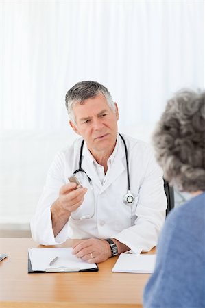 A senior doctor talking with his patient in his office Stock Photo - Budget Royalty-Free & Subscription, Code: 400-04813234