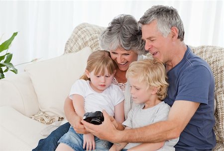 Family looking at their camera at home Stock Photo - Budget Royalty-Free & Subscription, Code: 400-04813297