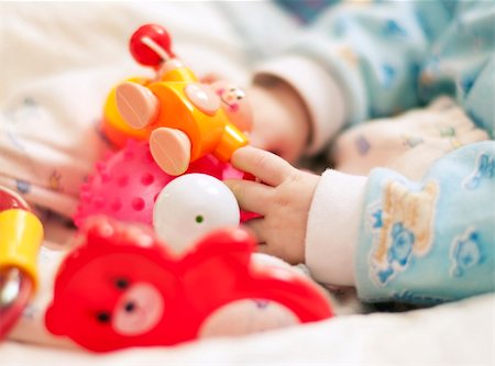 rattle - Close up hand with baby toys Stock Photo - Budget Royalty-Free & Subscription, Code: 400-04813534