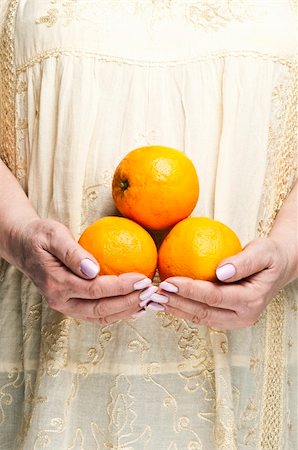 fuzzbones (artist) - Housewife holding bunch of orange fruits Stock Photo - Budget Royalty-Free & Subscription, Code: 400-04813974