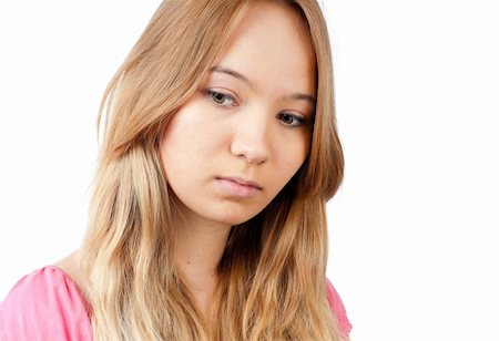 closeup of th beautiful teenage girl looking away from the camera with sad look at her face. Isolated on white background Fotografie stock - Microstock e Abbonamento, Codice: 400-04824237