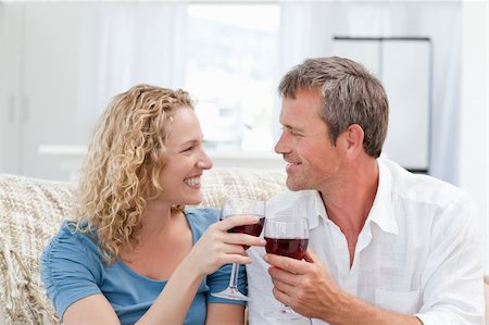 simsearch:400-04212835,k - Couple drinking some red wine in the living room at home Photographie de stock - Aubaine LD & Abonnement, Code: 400-04825117