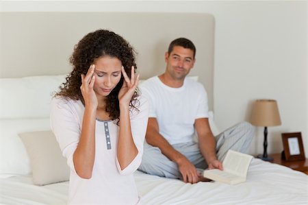 simsearch:649-03487806,k - Woman having a headache while her husband is reading Stock Photo - Budget Royalty-Free & Subscription, Code: 400-04825258