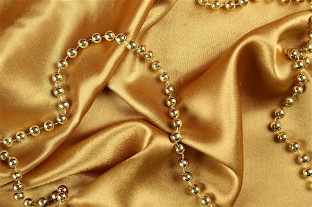sunny_baby (artist) - Background of gold cloth on which lay the golden beads Foto de stock - Royalty-Free Super Valor e Assinatura, Número: 400-04825470