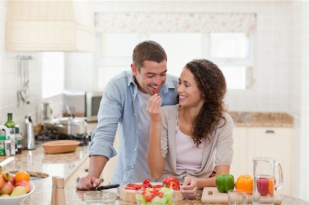 Man eating vegetables with his wife at home Stock Photo - Budget Royalty-Free & Subscription, Code: 400-04829097