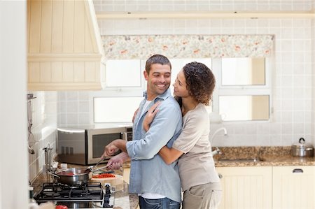 Lover couple cooking in the kitchen at home Stock Photo - Budget Royalty-Free & Subscription, Code: 400-04829361