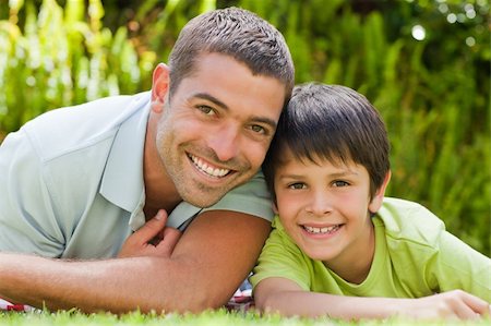 Father with his son lying down in the garden Stock Photo - Budget Royalty-Free & Subscription, Code: 400-04829428