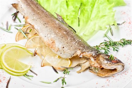 roasted fish - trout fish baked with greens close up Stock Photo - Budget Royalty-Free & Subscription, Code: 400-04829488