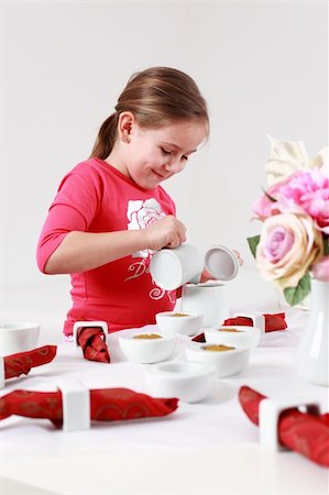 Girl helps to set the table - pouring tea Stock Photo - Budget Royalty-Free & Subscription, Code: 400-04829519