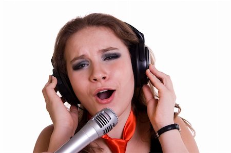 Young girl singing into microphone on white background. Singer. Foto de stock - Super Valor sin royalties y Suscripción, Código: 400-04829701