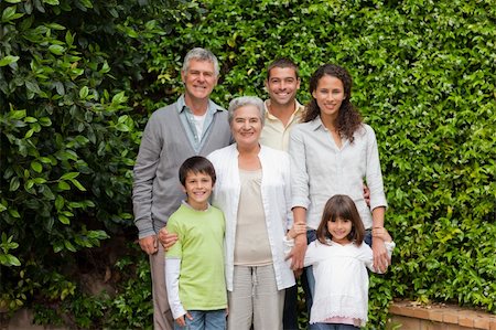 simsearch:400-06097548,k - Portrait of a happy family looking at the camera in the garden Photographie de stock - Aubaine LD & Abonnement, Code: 400-04829808