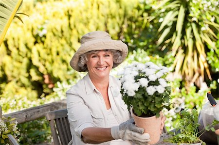 Senior woman with flowers in her garden Photographie de stock - Aubaine LD & Abonnement, Code: 400-04829825