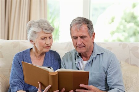 simsearch:400-04311095,k - Seniors looking at their photo album at home Stock Photo - Budget Royalty-Free & Subscription, Code: 400-04829896