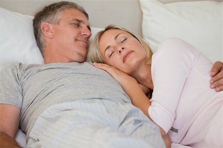 simsearch:400-04326193,k - Beautiful couple sleeping on their bed Stock Photo - Budget Royalty-Free & Subscription, Code: 400-04829897