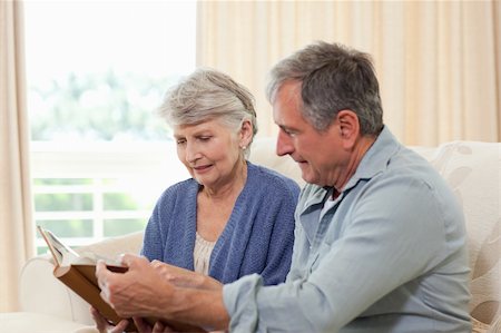 Seniors looking at their photo album at home Stock Photo - Budget Royalty-Free & Subscription, Code: 400-04829899