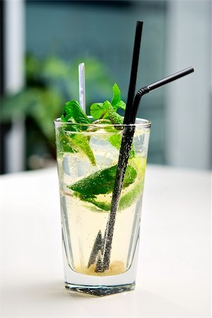 simsearch:400-04787910,k - Glass of cool mojito cocktail on a white table with a background of interior cafe Stock Photo - Budget Royalty-Free & Subscription, Code: 400-04820160