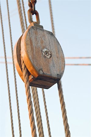 sailing block pulley - Wooden pulley with ropes against blue sky Stock Photo - Budget Royalty-Free & Subscription, Code: 400-04820417