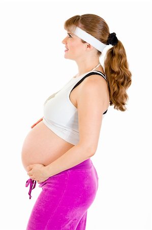 simsearch:400-04798379,k - Smiling beautiful pregnant woman in sportswear holding her belly isolated on white Foto de stock - Super Valor sin royalties y Suscripción, Código: 400-04820736