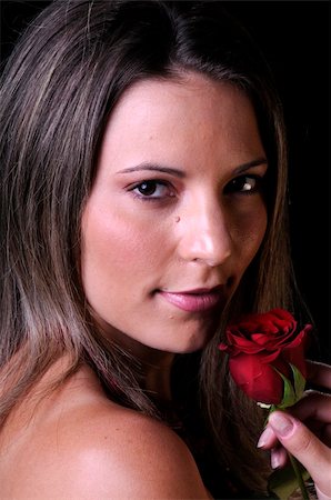 simsearch:400-04042499,k - Beautiful young brunette woman holding a red rose a sign of love for valentines or any other special occasion Stock Photo - Budget Royalty-Free & Subscription, Code: 400-04821704