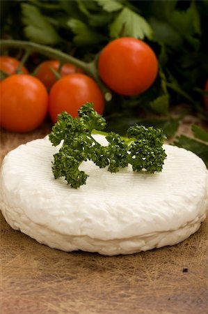 ricotta - photo of fresh round ricotta cheese with vegetables arround on wood table Stock Photo - Budget Royalty-Free & Subscription, Code: 400-04822366