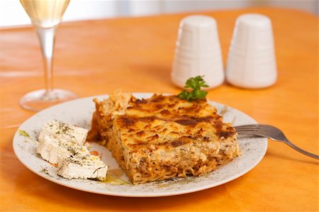 Pastitsio greek food on a table, wine alcohol drink salt and pepper Stock Photo - Budget Royalty-Free & Subscription, Code: 400-04822991