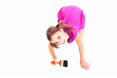 Top view of a happy girl sitting on floor holding a paint-brush Stock Photo - Budget Royalty-Free & Subscription, Code: 400-04823130