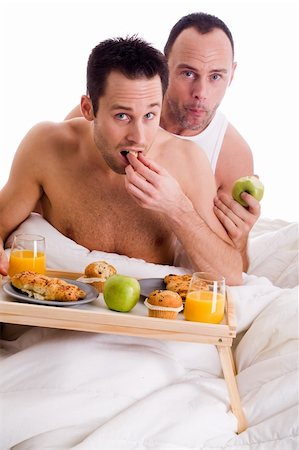A Happy homo couple and their breakfast on a tray in bed Stock Photo - Budget Royalty-Free & Subscription, Code: 400-04823323