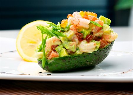 Salad from prawn and avocado on the table in cafe. Defocused background Fotografie stock - Microstock e Abbonamento, Codice: 400-04823333