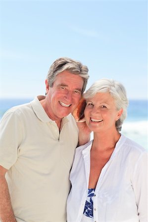 Retired couple listening to their shell Stock Photo - Budget Royalty-Free & Subscription, Code: 400-04834329