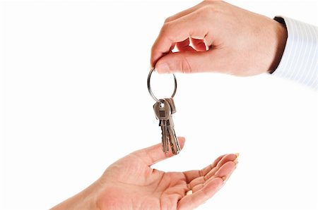 finger holding a key - Agent man hand giving keys to woman Photographie de stock - Aubaine LD & Abonnement, Code: 400-04835106