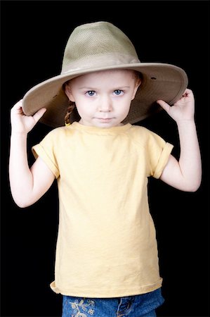 strotter13 (artist) - A young girl with a jungle style safari hat on.  Her hands are on the hat and she is pulling it down. Photographie de stock - Aubaine LD & Abonnement, Code: 400-04835278