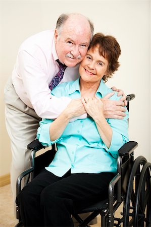simsearch:400-04109826,k - Loving, supportive husband gives his disabled wife a hug. Fotografie stock - Microstock e Abbonamento, Codice: 400-04835472