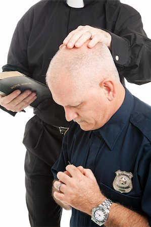 Policeman prays and receives a blessing from his priest or minister. Photographie de stock - Aubaine LD & Abonnement, Code: 400-04835473