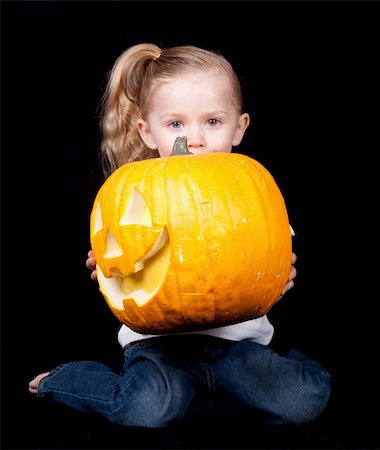 strotter13 (artist) - A young child is holding a pumpkin.  The pumpkin is sideways and the child is kneeling. Photographie de stock - Aubaine LD & Abonnement, Code: 400-04835573