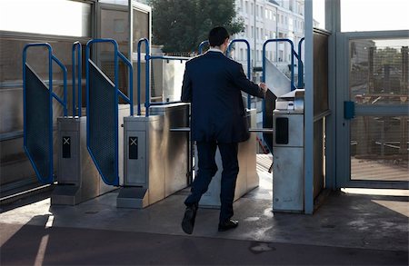 The man passes through a turnstile in the underground. Paris, France Fotografie stock - Microstock e Abbonamento, Codice: 400-04836903