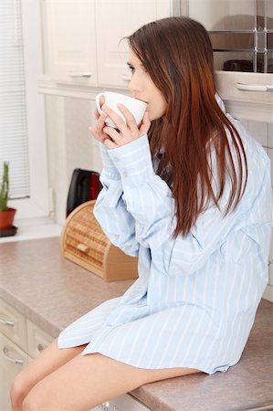 simsearch:400-04335902,k - A young woman having morning coffee or tea in the kitchen Photographie de stock - Aubaine LD & Abonnement, Code: 400-04837090